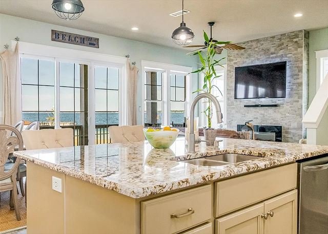 Open-concept kitchen island and dining table with water views